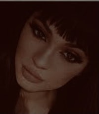 a black and white photo of a woman with bangs